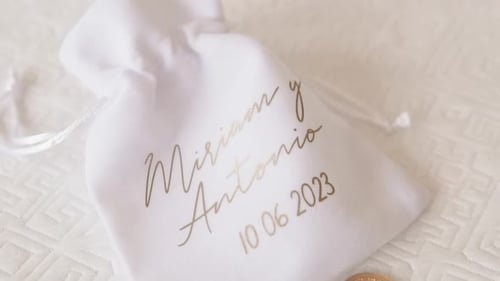 Close up coin bag for wedding, decoration with names and date.