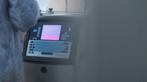 Factory Worker Check Quality of Product on Automated Production Line at Dairy