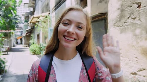 Portrait of Beautiful Backpacker Tourist Girl Waving at Camera on Bangkok Asian