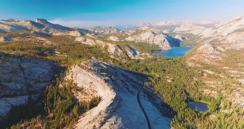 Yosemite National Park scenery in the rays of hot bright sun. Beautiful rocks, pine tree woods