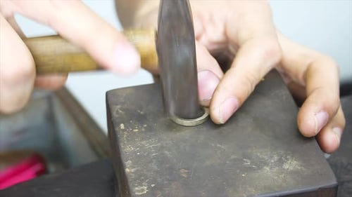 Metal jewelry manufacturing, professional handmade ring by hammer, forming structure