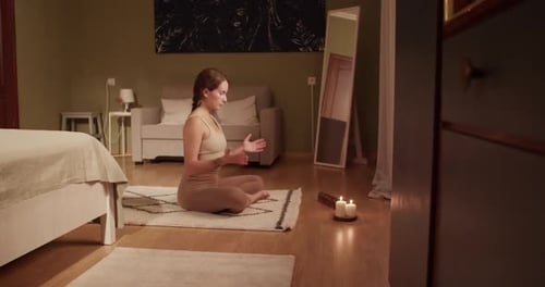 Woman Meditating in Lotus Position at Home