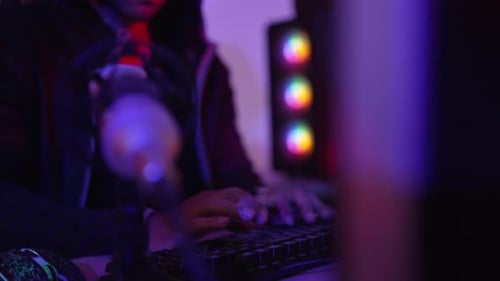 Young Adult Typing on Keyboard at Computer