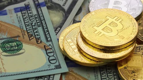 Close-up of Bitcoin Coins and US Currency