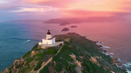 Breathtaking sunset over a lighthouse on the rocky coastline in autumn