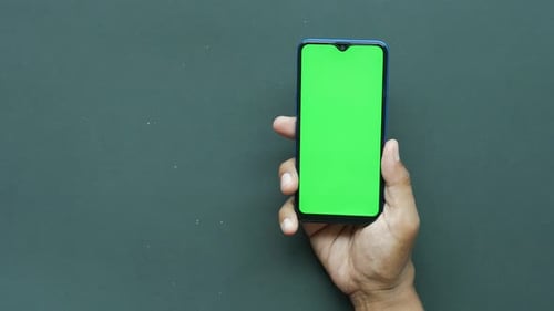 Close Up of Young Man Hand Using Smart Phone with Green Screen