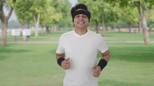 Glücklicher indischer Mann beim Joggen