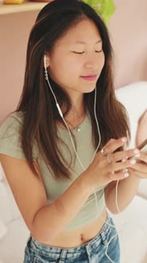 Young Woman Listens to Music with Headphones