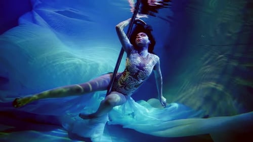 Underwater a Woman Becomes Part of a Luminous Underwater Ball Where Her Every Look and Movement are