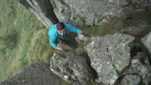 Dangerous Rock Climbing in the Mountains Man Climbs a Mountain in Cloudy Weather