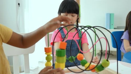 Happy two children playing with puzzle. Educational toys for preschool and kindergarten