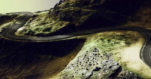 Curvy Mountain Road Winding Through Rocky Landscape Under Soft Light