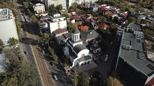 Aerial drone view of a church, capturing its architecture, roof, and surrounding area