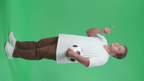 Full Body Of Asian Man With A Ball Putting Hand On His Chest And Pointing Forward On Green Screen