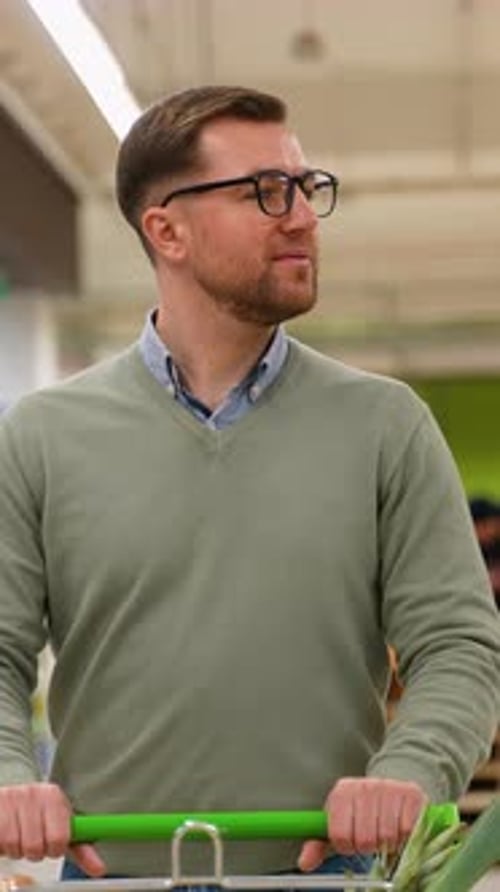 Man Grocery Shopping for Fresh Produce in Supermarket