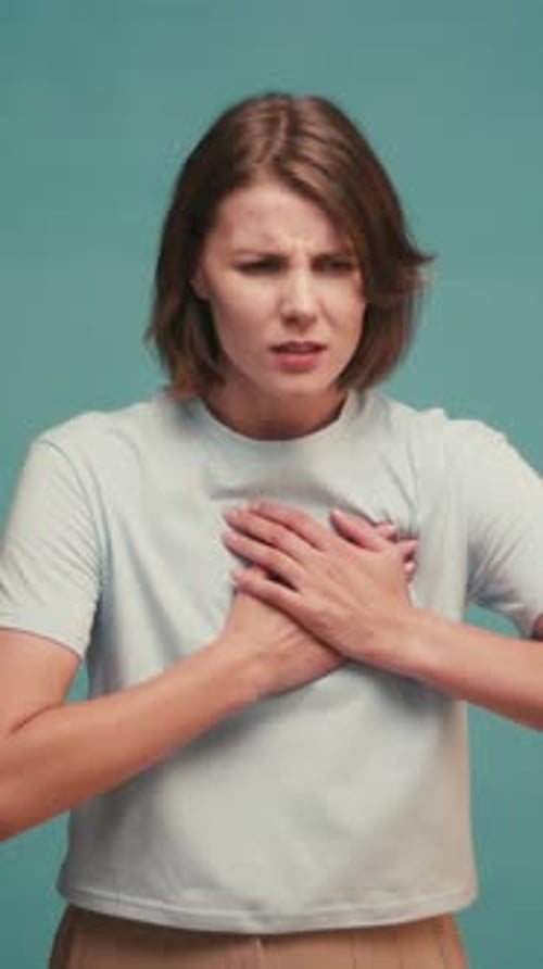Woman with Pain on Heart Young Female Presses Hand to Chest Has Heart Attack Suffers From Unbearable