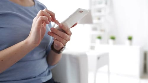 Woman Using Smartphone in Bright Modern Interior