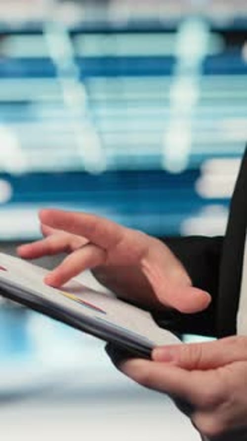 Vertical Video Close Up of Data Center Engineer Reading Clipboard Files Charts