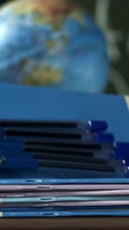 Notebooks and Pens Fall on the School Desk Filmed on a Highspeed Camera at 1000 Fps