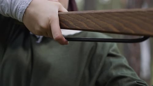 Girl in Old Styled Clothes Presses Trigger of Crossbow