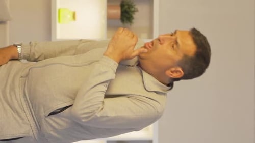 Vertical video of The sick man can't stop coughing.