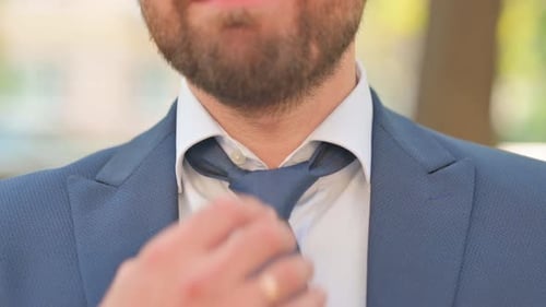 Close up of Businessman Opening Necktie Outdoor