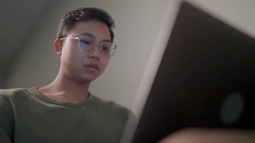 Young Adult Using Computer in Home