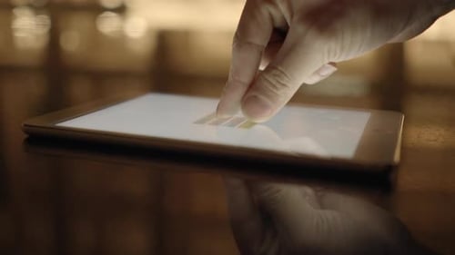 Finger Touching Tablet Screen With Charts