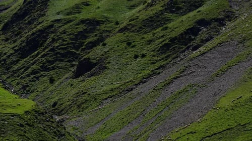A Mountain with a Green Hillside and a Rocky Cliff