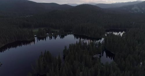 Aerial Over Blue Lake in Colorado Surrounded by Forest, Soaring Over Crystal Clear Water in Colorado