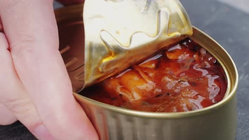 Opening Canned Octopus Squid Fish Can Man Open the Canned Seafood on the Table Close Up on