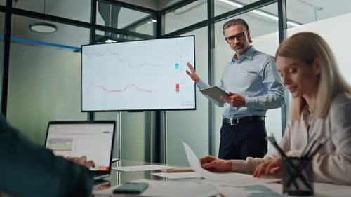 Business Presentation With Financial Charts in Modern Office