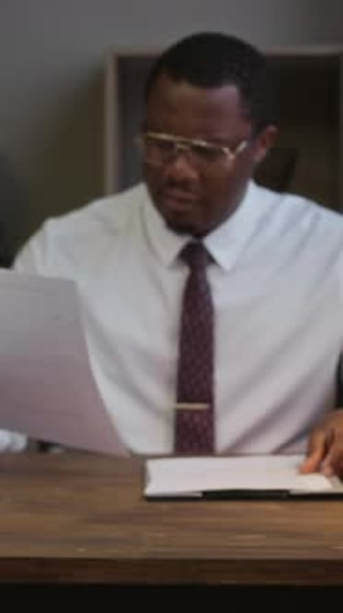 Portrait of Male Principal Working at School Office Table