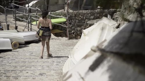 Slow Motion View of a Young European Girl Walking Down Some Stone Stairs in the Sunlight