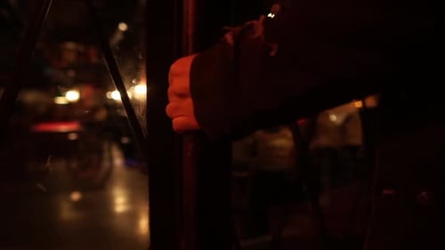 Man open a door and goes into a bar