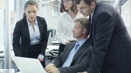 Team of Office Workers Have Discussion next to Computer