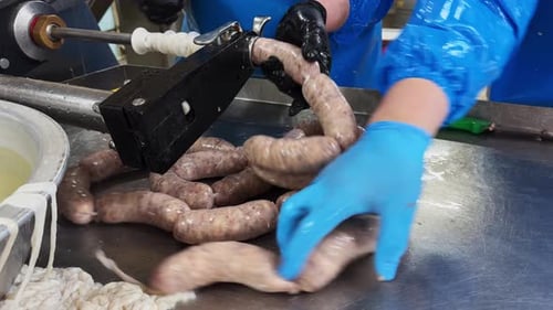 Close up of sausages production process at the meat factory
