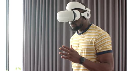 Man Experiencing Virtual Reality Headset at Home