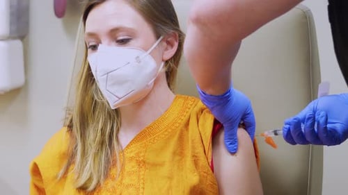 Medical Professional Administers Injection to Patient