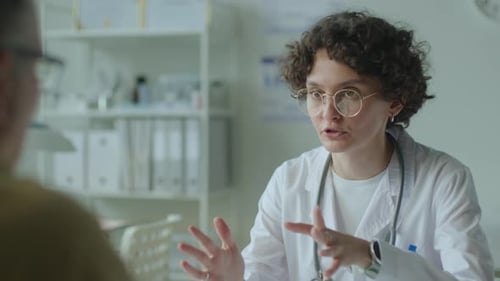Female Physician Having Conversation with Patient in Clinic
