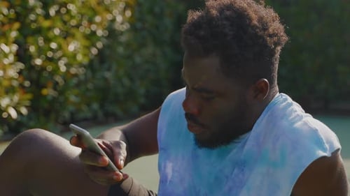 Young Man Using Mobile Device Outdoors