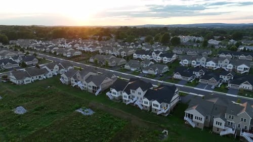 Hundreds of houses in American neighborhood. Community of family homes in suburban area.