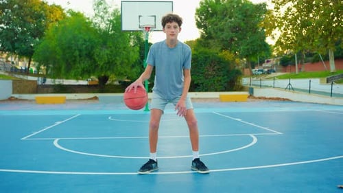 Slow Motion Street Basketball Boy Practicing Shooting a Basketball The Teenager Plays Basketball