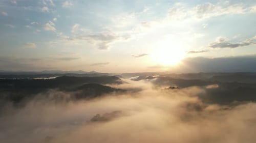 Aerial View of Foggy Mountains at Sunrise