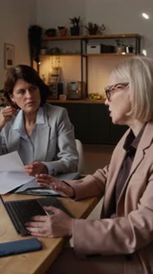 Trio of Professional Middle-Aged Women Engaged in Collaborative Tasks in Office