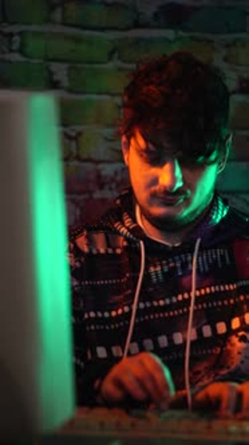 Vertical View of Young Man Working on Old PC Computer From 1990's