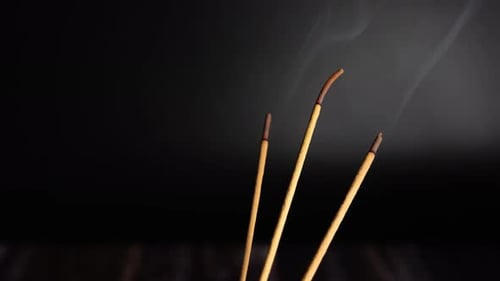 Incense Sticks Burning Aromatically with Wisps of Smoke