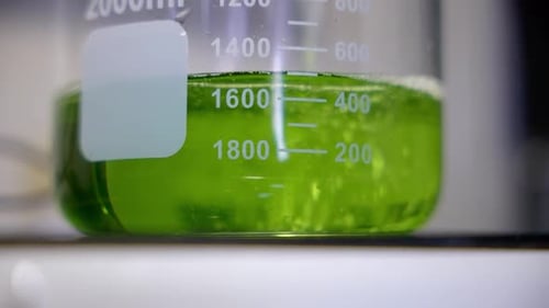 Close up of a pouring green liquid for test in laboratory