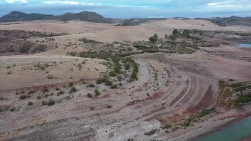 Aerial view of dried out riverbed and arid hills in Spain
