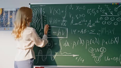 Woman Teaching Physic School Writing Data on Classroom Blackboard Closeup
